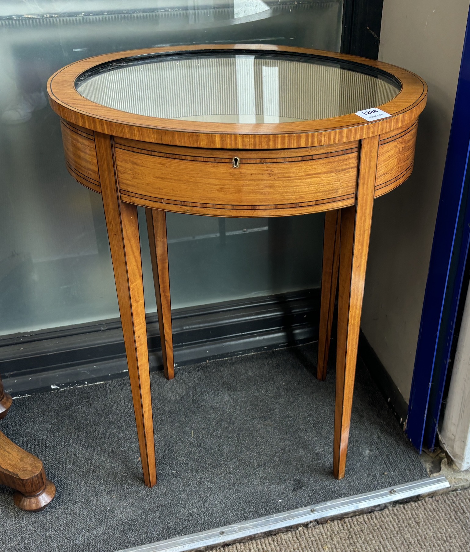 A Sheraton style satinwood oval bijouterie table, width 57cm, depth 45cm, height 70cm